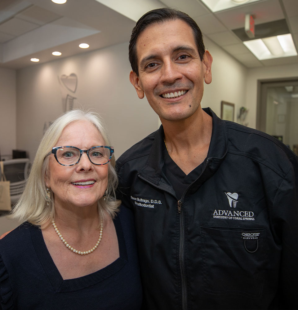 patient and doctor smiling together within the dental center